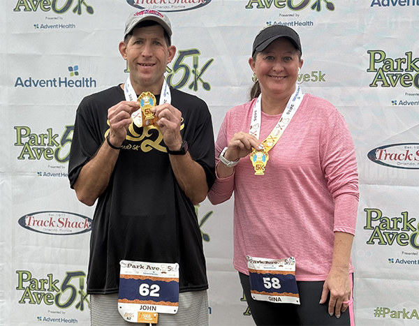 Runners holding Park Ave 5K medals